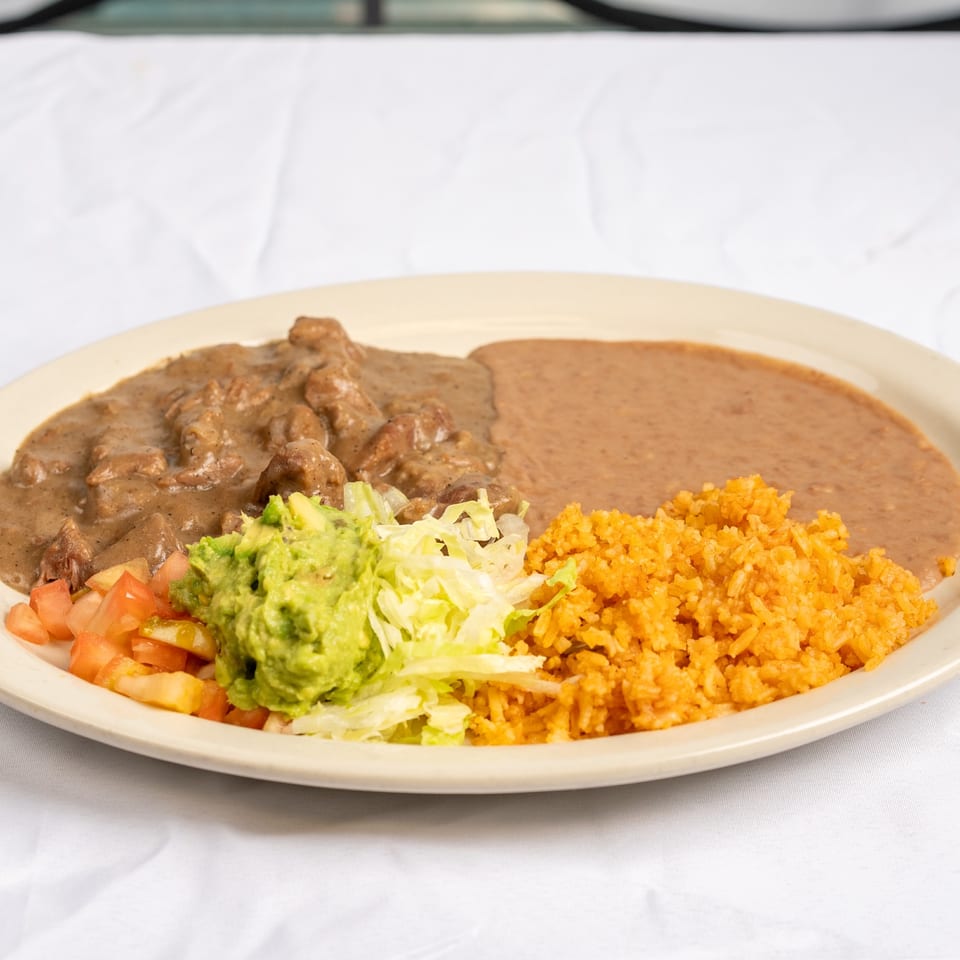 Carne guisada with rice, beans and guacamole.