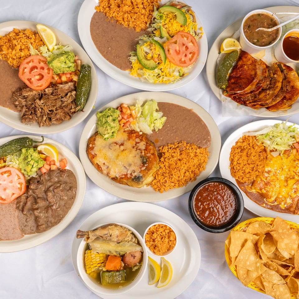 A selection of Tex-Mex dishes with rice, beans, chips and salsa.