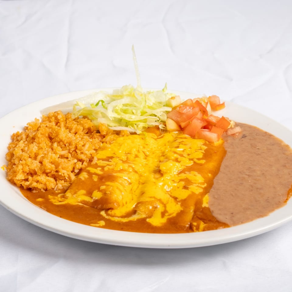 Enchiladas with melted cheese, rice and refried beans.