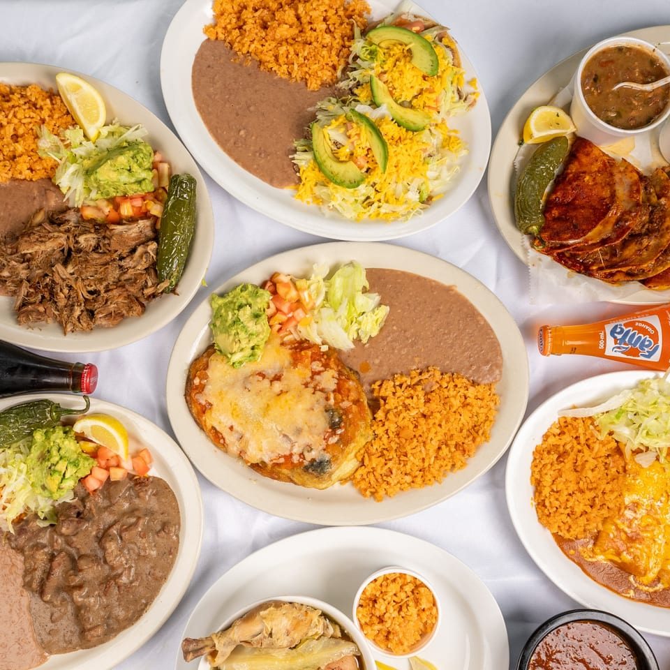 Tex-Mex plates alongside bottled soft drinks.