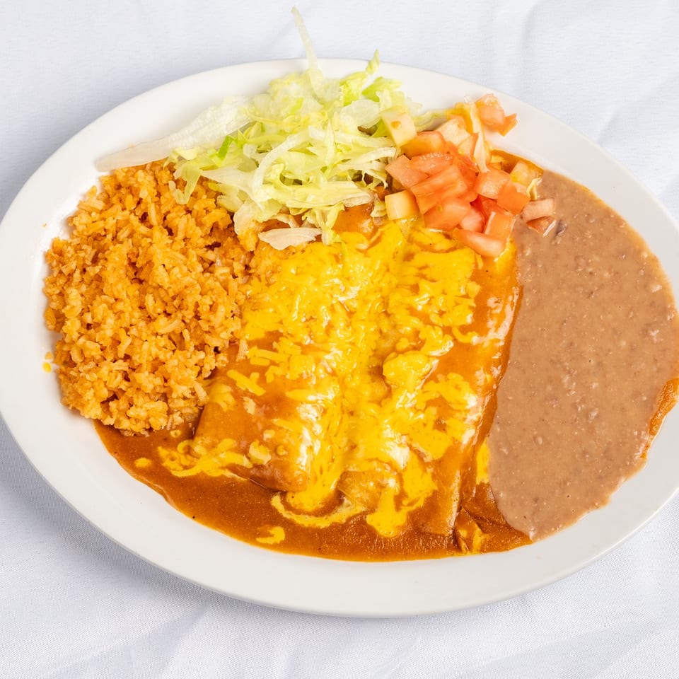 Enchiladas with melted cheese, rice and refried beans.